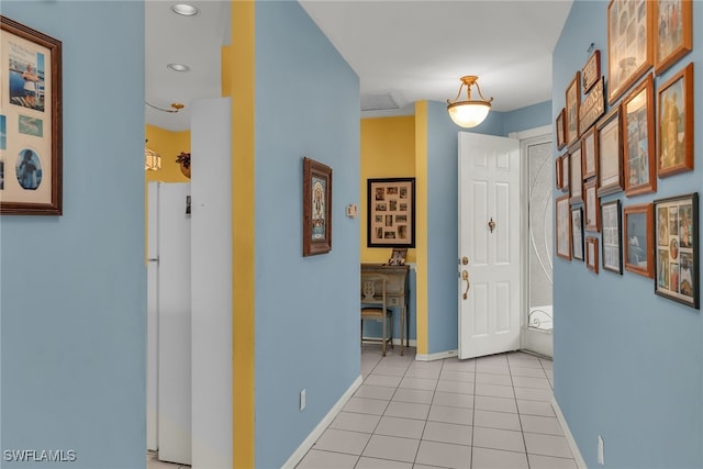 corridor with light tile patterned floors, recessed lighting, and baseboards