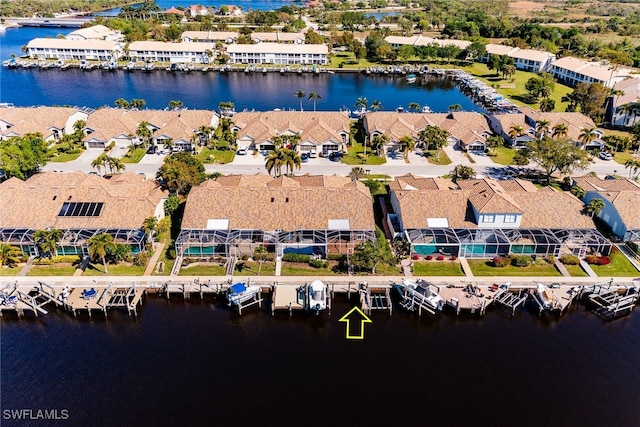 drone / aerial view with a residential view and a water view