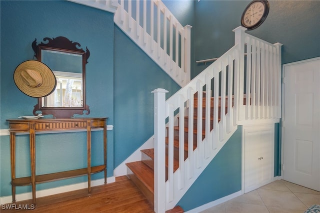 stairs featuring tile patterned floors