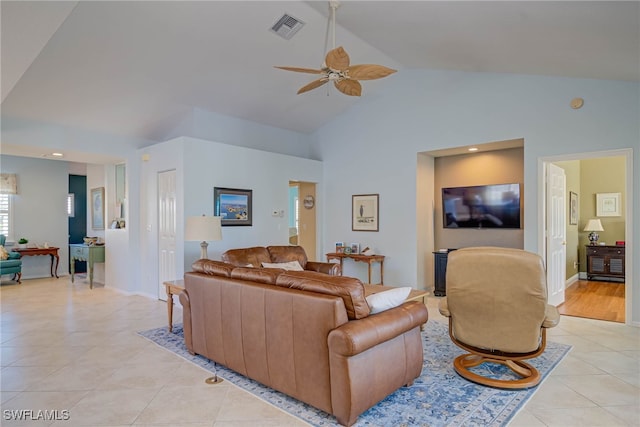 living area featuring visible vents, baseboards, ceiling fan, light tile patterned flooring, and high vaulted ceiling