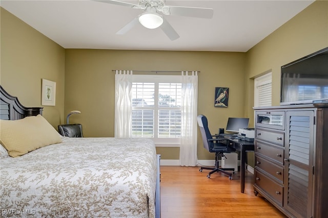 bedroom featuring baseboards, ceiling fan, and light wood finished floors