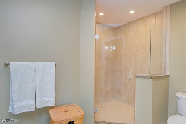 full bath with a shower stall, toilet, and recessed lighting