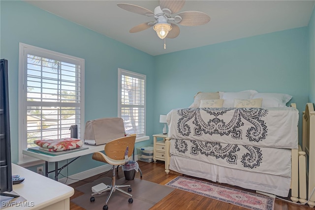 bedroom with wood finished floors, baseboards, and ceiling fan