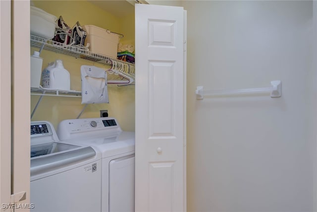 clothes washing area featuring laundry area and separate washer and dryer