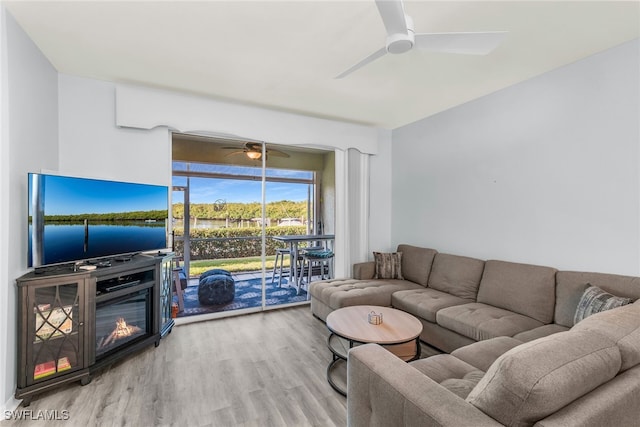 living room featuring wood finished floors and a ceiling fan