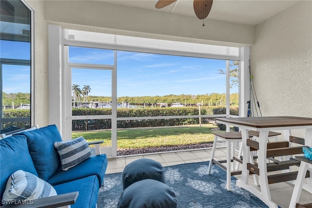 sunroom / solarium featuring a healthy amount of sunlight and ceiling fan