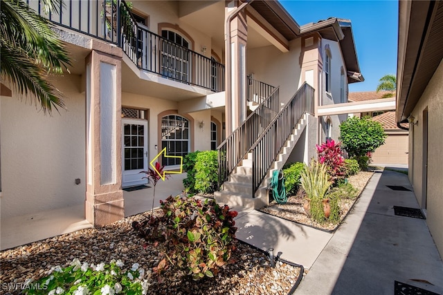 property entrance with stucco siding