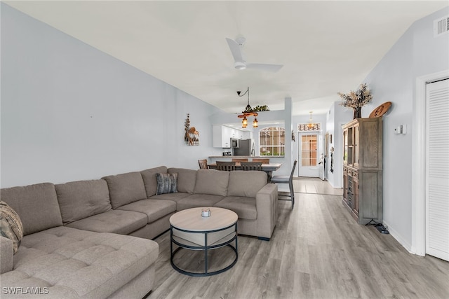 living area with ceiling fan, visible vents, baseboards, and light wood-style flooring