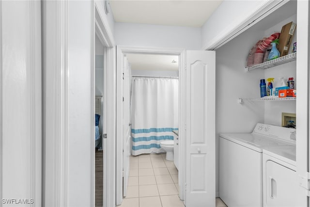 laundry area featuring light tile patterned flooring, laundry area, and independent washer and dryer