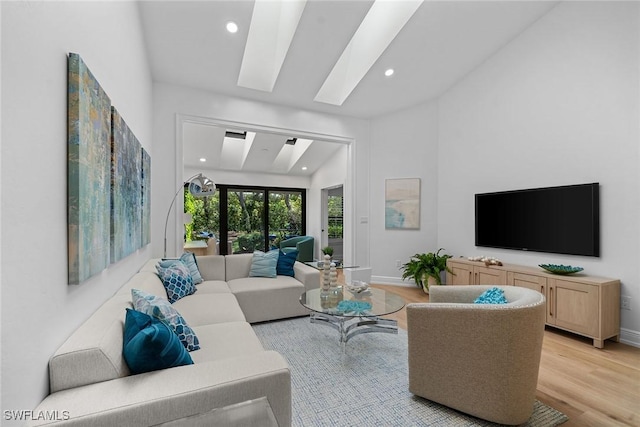 living room with recessed lighting, light wood-style floors, and baseboards