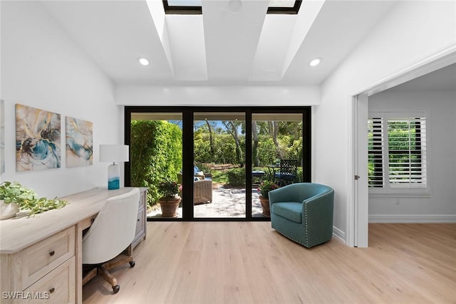 home office featuring recessed lighting, baseboards, built in desk, and light wood finished floors