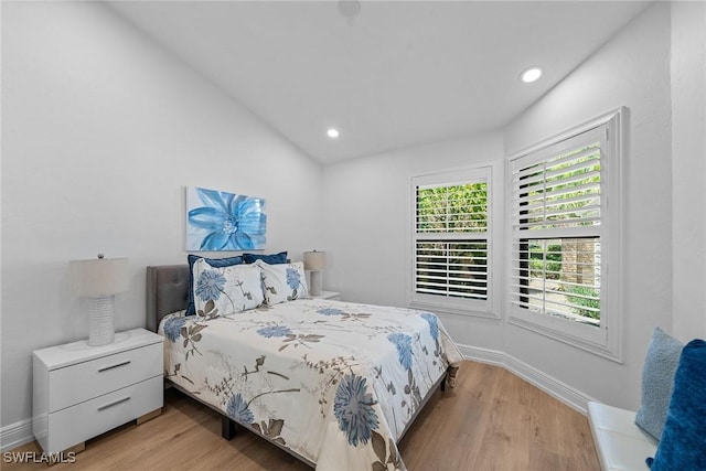 bedroom featuring recessed lighting, light wood-type flooring, baseboards, and vaulted ceiling