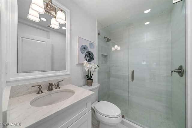 full bathroom with vanity, toilet, and a shower stall