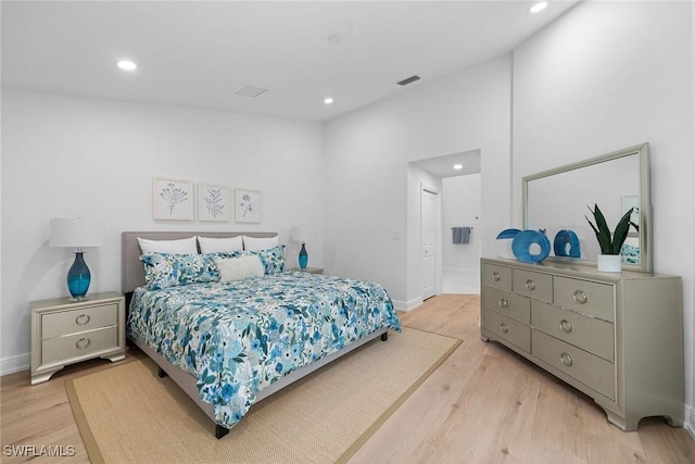 bedroom with light wood-style flooring, recessed lighting, visible vents, and baseboards