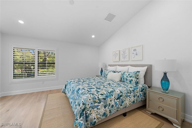 bedroom with visible vents, baseboards, lofted ceiling, recessed lighting, and wood finished floors