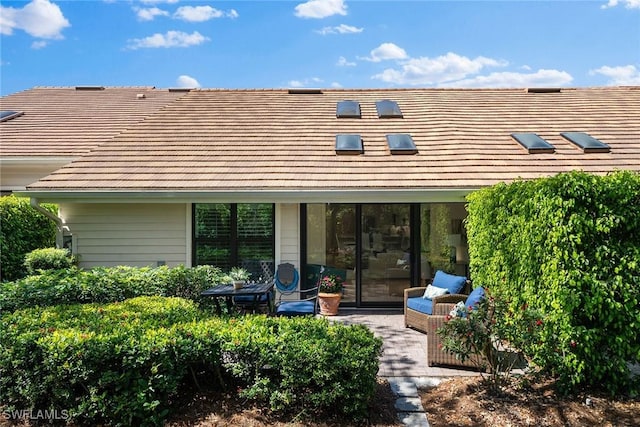 rear view of property with a tiled roof