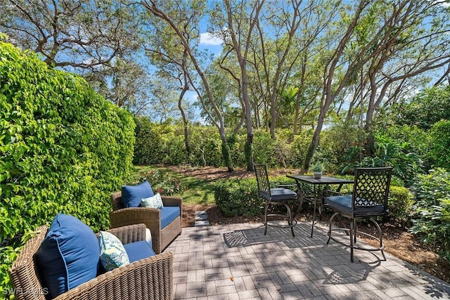 wooden deck with outdoor dining space and a patio