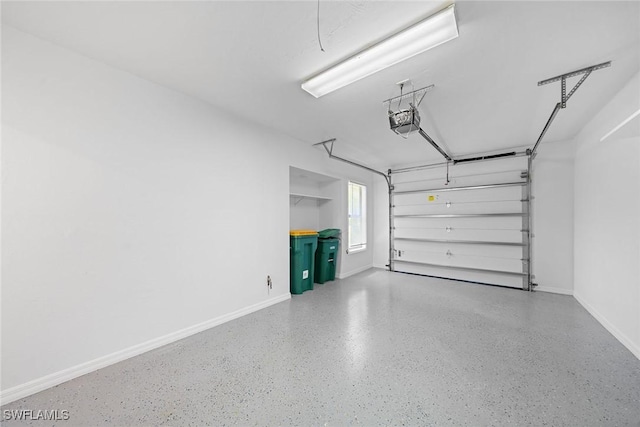 garage featuring a garage door opener and baseboards