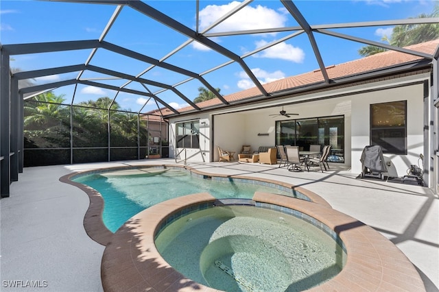 view of swimming pool with ceiling fan, a patio, a lanai, and a pool with connected hot tub