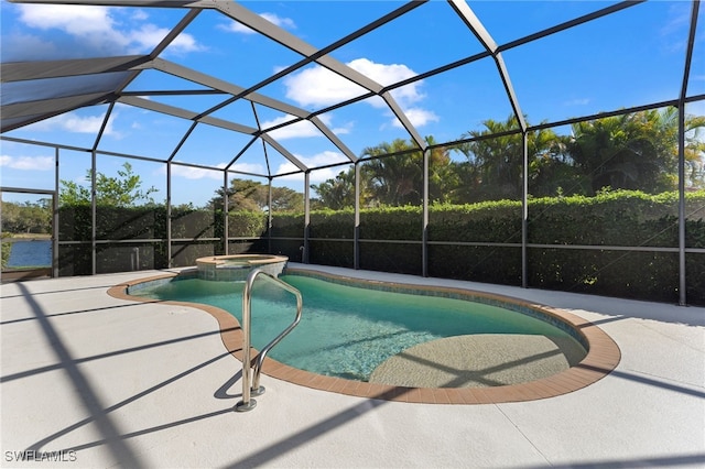 view of pool with a patio, a pool with connected hot tub, and a lanai
