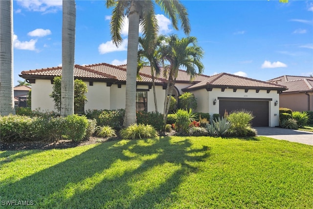 mediterranean / spanish house with stucco siding, a tiled roof, driveway, and a front lawn