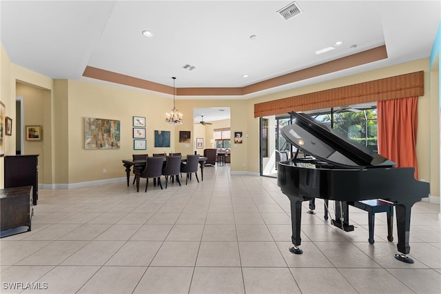 interior space featuring visible vents, a notable chandelier, a tray ceiling, light tile patterned flooring, and baseboards