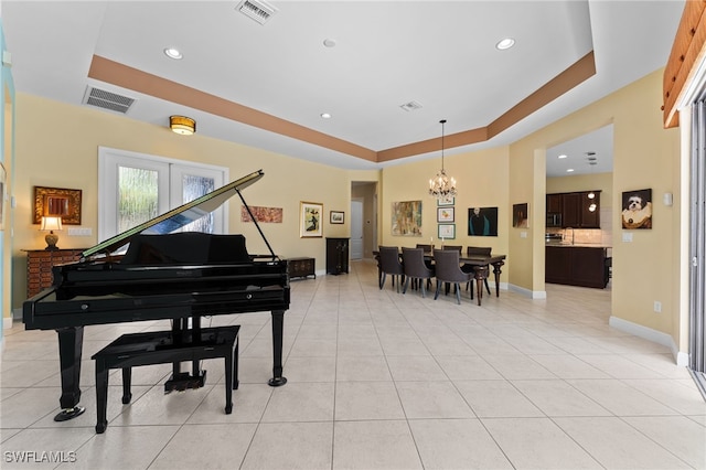 interior space featuring a chandelier, visible vents, a raised ceiling, and light tile patterned flooring