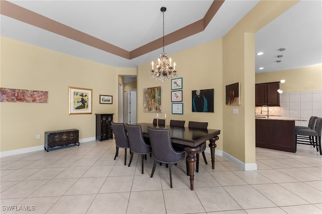 dining area with light tile patterned floors, a notable chandelier, and baseboards