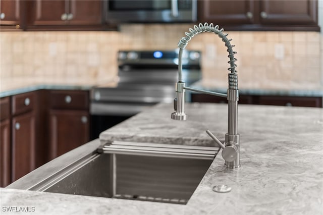 details featuring tasteful backsplash and light stone counters
