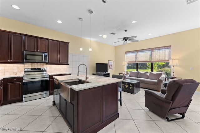 kitchen with tasteful backsplash, open floor plan, and stainless steel appliances