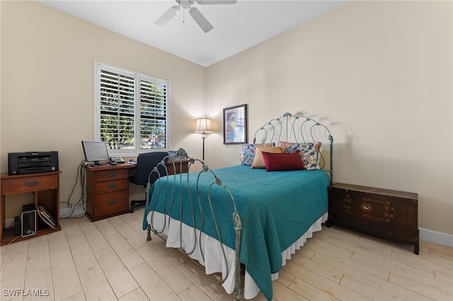 bedroom featuring baseboards, ceiling fan, and wood finished floors