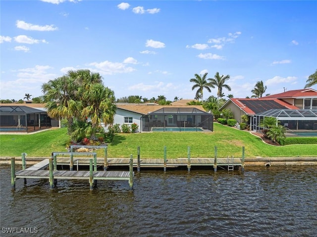 view of dock with glass enclosure, a water view, and a lawn