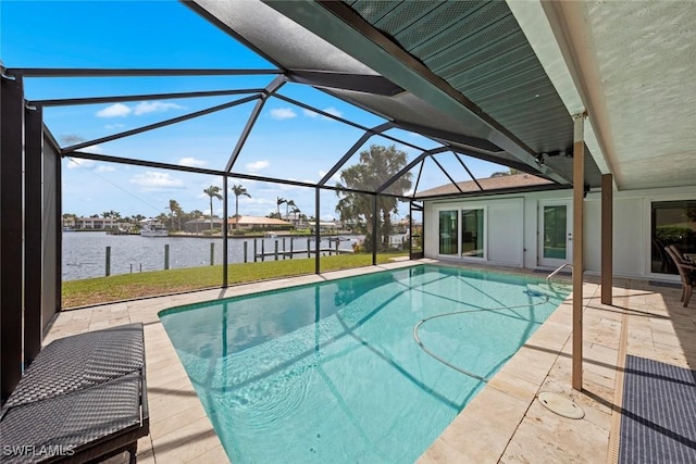 pool featuring a patio, a yard, a water view, and a lanai