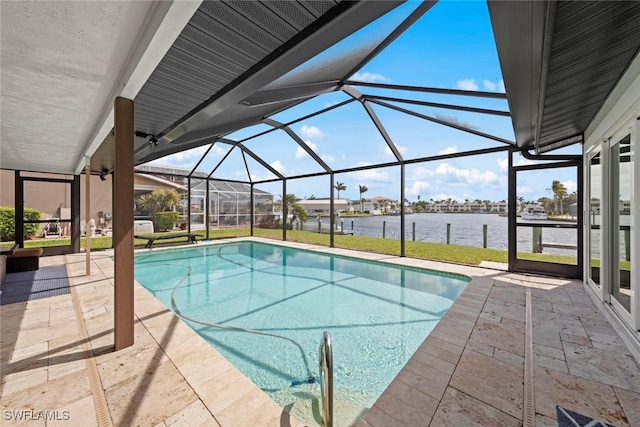 pool featuring glass enclosure, a patio, and a water view