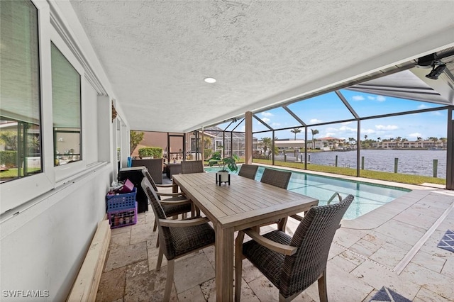 view of patio with an outdoor living space, a water view, glass enclosure, outdoor dining space, and an outdoor pool