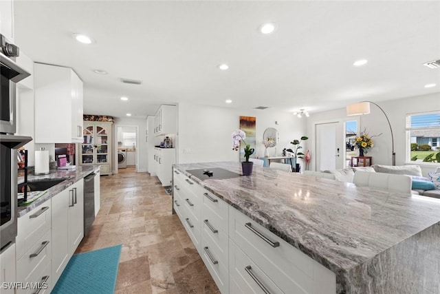 kitchen featuring recessed lighting, visible vents, washer / dryer, and dishwasher