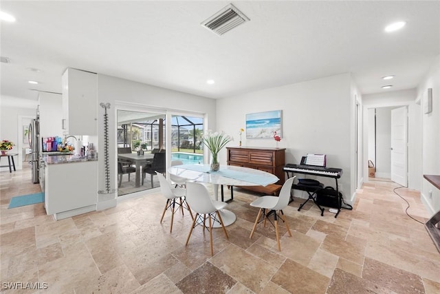 dining space featuring baseboards, recessed lighting, visible vents, and stone tile flooring