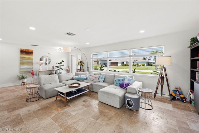 living area featuring recessed lighting, visible vents, baseboards, and stone tile flooring