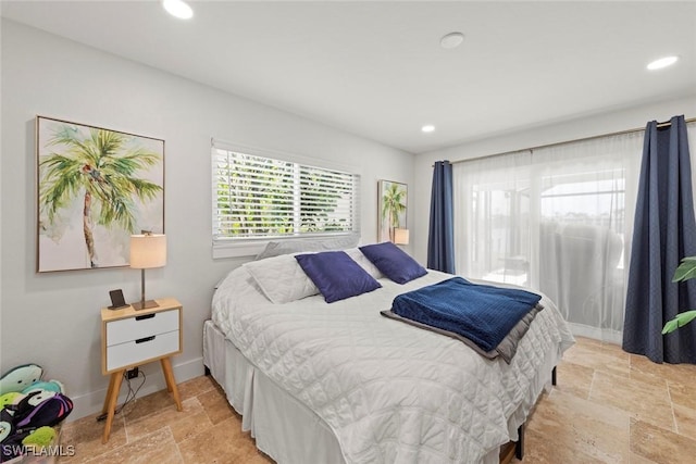 bedroom with recessed lighting, baseboards, and stone tile flooring