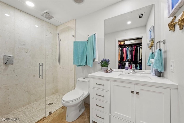 full bathroom featuring visible vents, a shower stall, toilet, and vanity