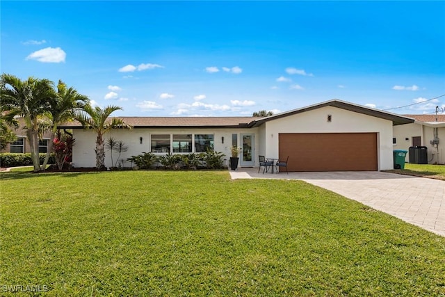 single story home with stucco siding, a front lawn, decorative driveway, cooling unit, and an attached garage