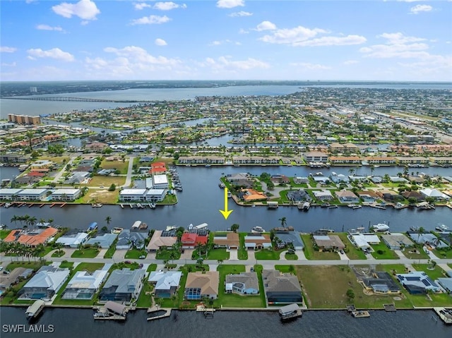 drone / aerial view with a water view and a residential view