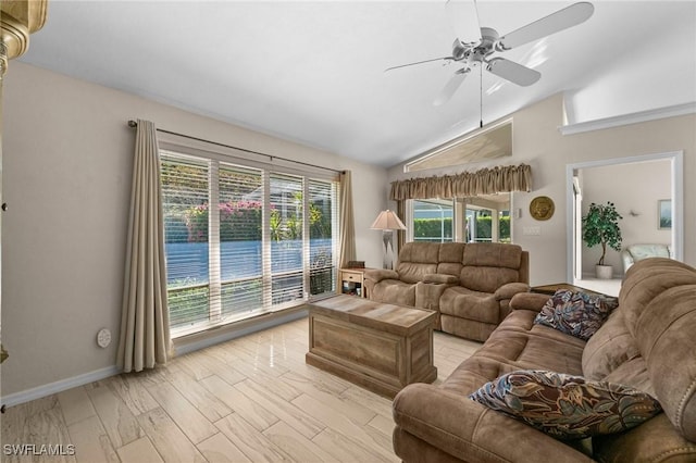 living area featuring light wood-style flooring, lofted ceiling, baseboards, and ceiling fan