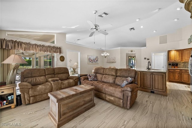 living area with visible vents, vaulted ceiling, and ceiling fan with notable chandelier