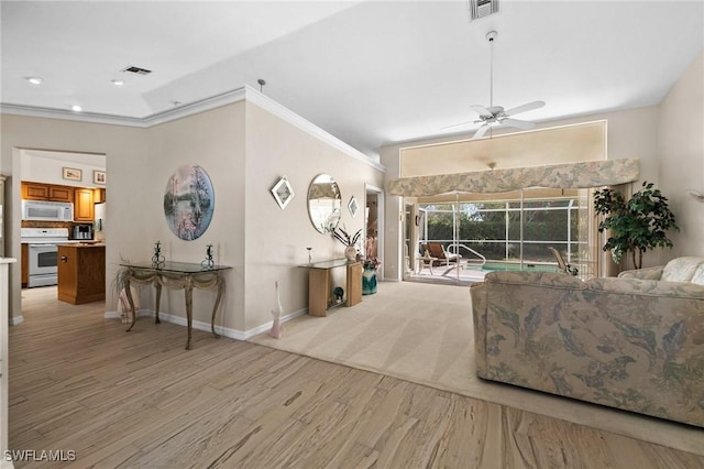 living area featuring visible vents, light wood finished floors, a ceiling fan, and crown molding