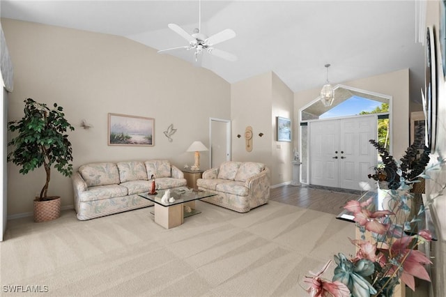 carpeted living area with high vaulted ceiling and baseboards