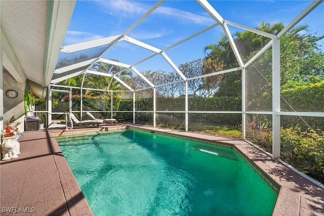 view of swimming pool featuring a lanai, a patio area, and a fenced in pool