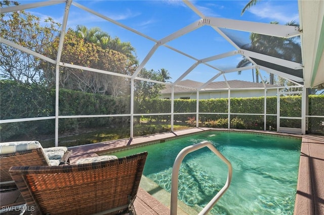 view of swimming pool with glass enclosure, a patio, and a fenced in pool