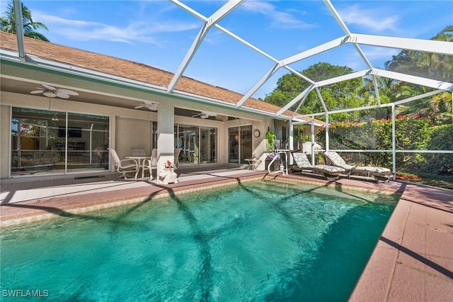 outdoor pool featuring a lanai, a ceiling fan, and a patio area