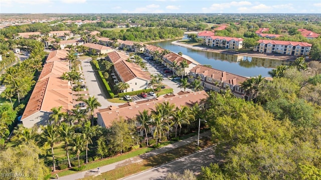 drone / aerial view featuring a residential view and a water view